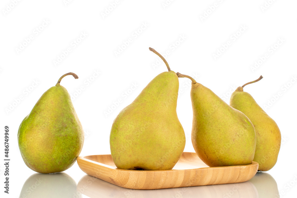 Four sweet juicy pears on a bamboo tray, macro, isolated on a white background. Four sweet juicy pears on a bamboo tray, macro, isolated on a white background.