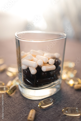 Vitamins and dietary supplements close-up. Macrophoto of capsules. Vitamins on the table.