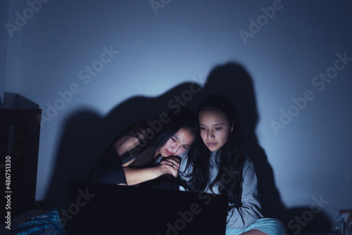 Young women at a sleepover watching very interesting and suspenseful movies.