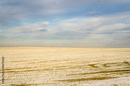 Empty winter landscape with meadows and fields on a snowy day