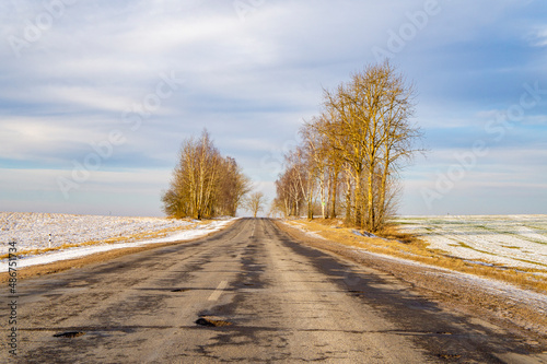 Empty winter asphalt suburban road