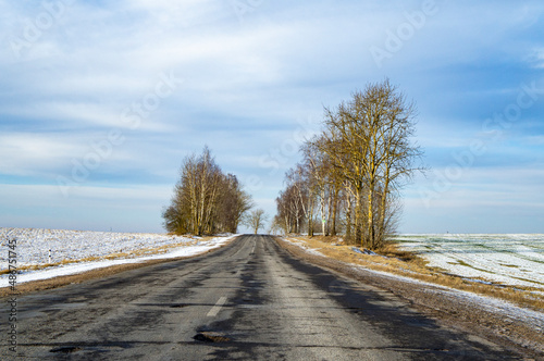 Empty winter asphalt suburban road