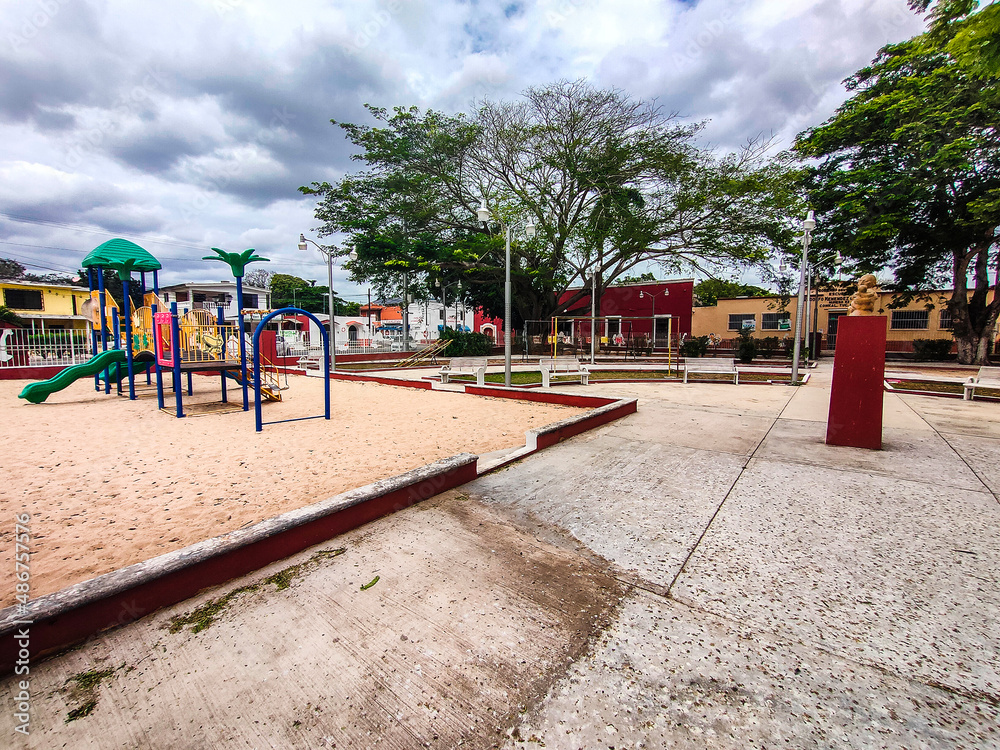 Children's playground in the town of Conkal with an old church in the background Children's playground in the town of Conkal with an old church in the background