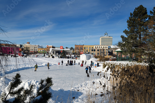 Skaters on Heritagae Park Pond at Barrie Winterfest called Hello Winter in 2022 with ice sculptures photo