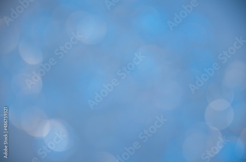 Color background.Holiday template. Bokeh on a colored background.