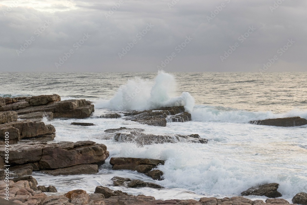 Waves crashing onto rocks on the south coast of South Africa