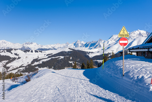 A Megeve ski slope in the middle of the mountains of the Mont Blanc massif in Europe, France, Rhone Alpes, Savoie, Alps, in winter, on a sunny day.