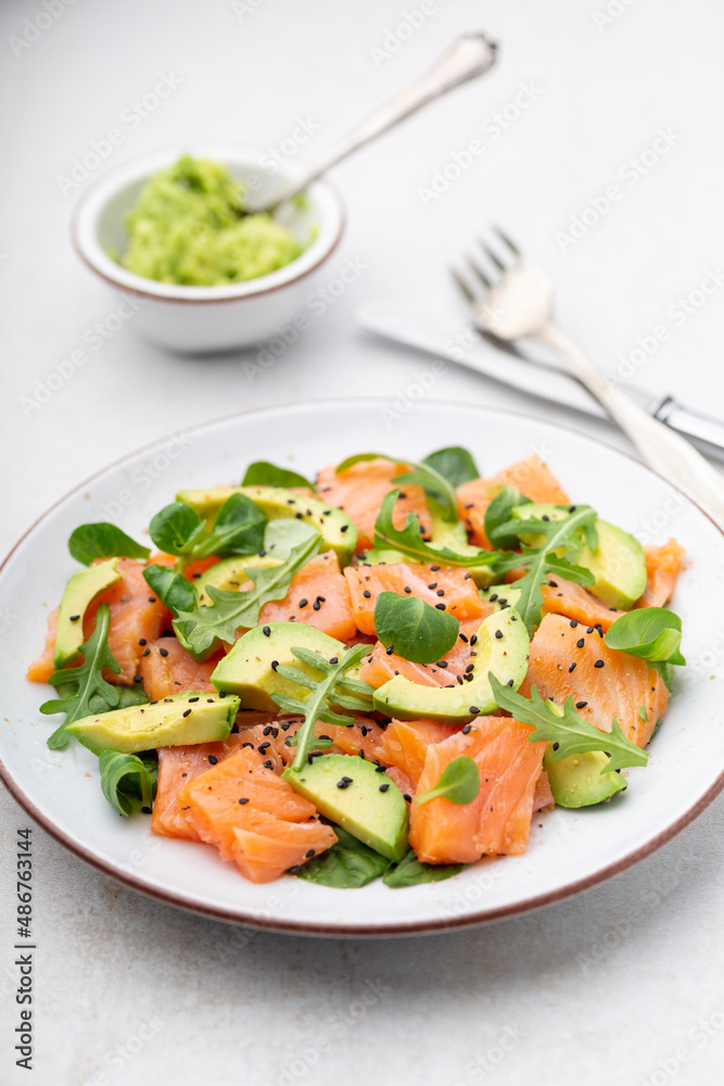 Fresh salmon salad with avocado, for keto and low carb diet. Rusty background, top view, copy space. Fresh salmon salad with avocado, for keto and low carb diet. Rusty background, top view, copy space.