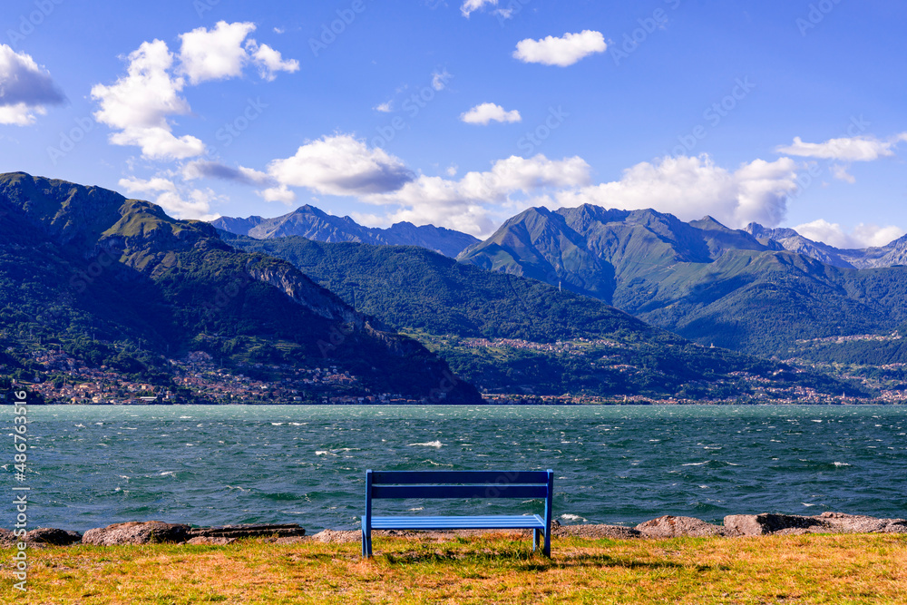 Take a break on a bench with view on the mountains of Lago di Como Italy Take a break on a bench with view on the mountains of Lago di Como Italy
