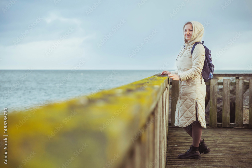 Woman standing on a pier in winter Denmark