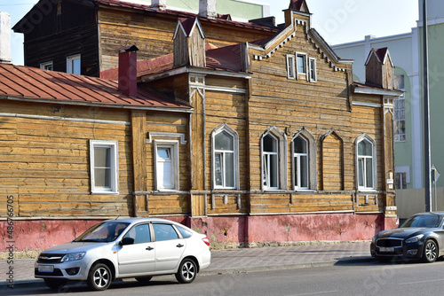 City street and old wooden house.