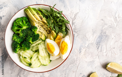 Diet menu. Healthy lifestyle bowl with avocado, cucumber, broccoli and egg. Healthy organic vegan salad. Delicious breakfast or snack, Clean eating, dieting, vegan food concept. top view