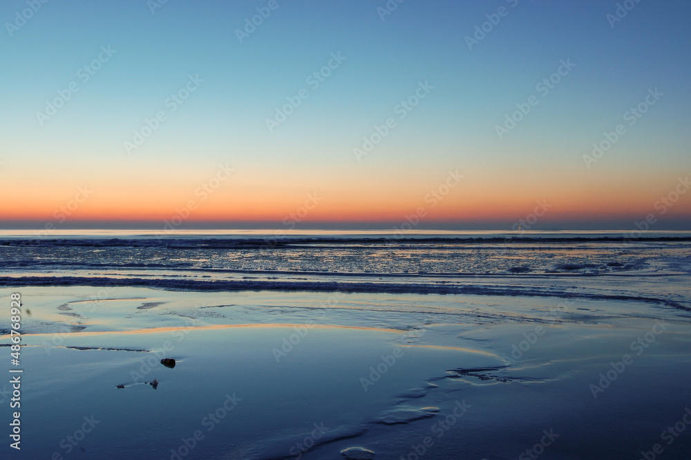 Frozen Baltic sea during a beautiful calm sunset in Liepaja, Latvia