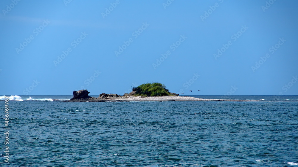 Small islet in the bay, in Tamarindo, Costa Rica Small islet in the bay, in Tamarindo, Costa Rica