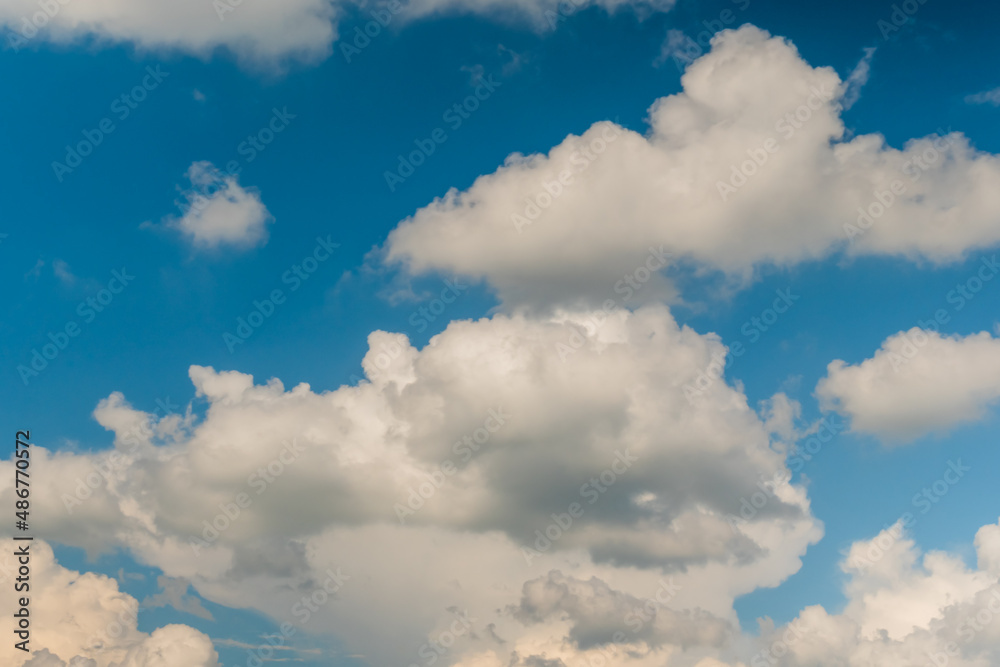 White clouds against blue sky. Daylight, cloudy day. Nature, freedom and peaceful concept White clouds against blue sky. Daylight, cloudy day. Nature, freedom and peaceful concept