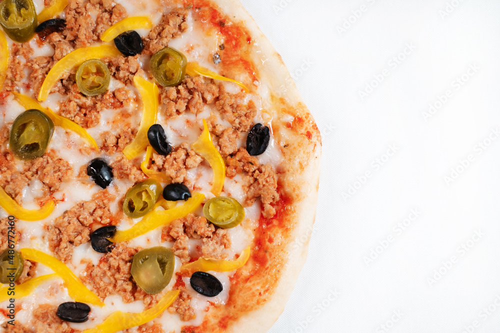 Colorful pizza with cucumbers jalapeno peppers and olives close-up. Colorful pizza with cucumbers jalapeno peppers and olives close-up.