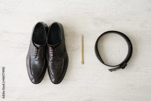 Stylish men's accessories: handle and belt, as well as shoes. Top view
