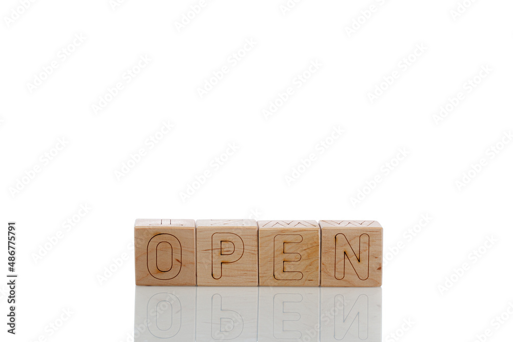 Fototapeta premium Wooden cubes with letters open on a white background