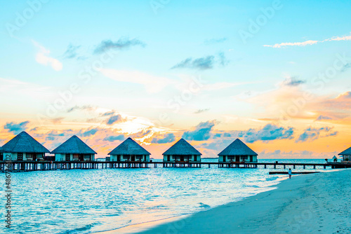 Fototapeta Naklejka Na Ścianę i Meble -  view of the water villas at sunrise in the Maldives, the concept of luxury travel
