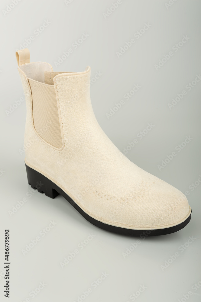 women's rubber boots on a uniform background