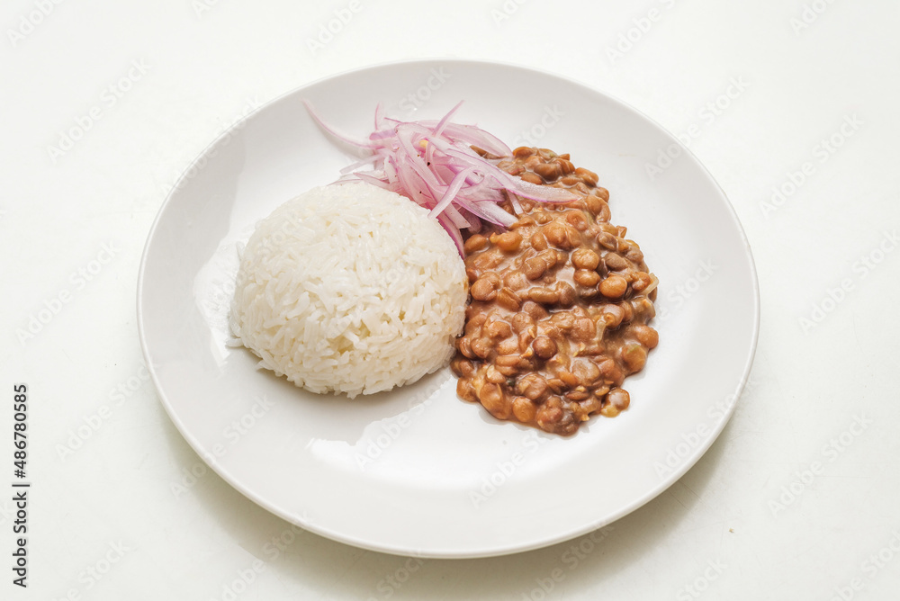 Lentiles portion served with rice and onion salad. Lentiles portion served with rice and onion salad.