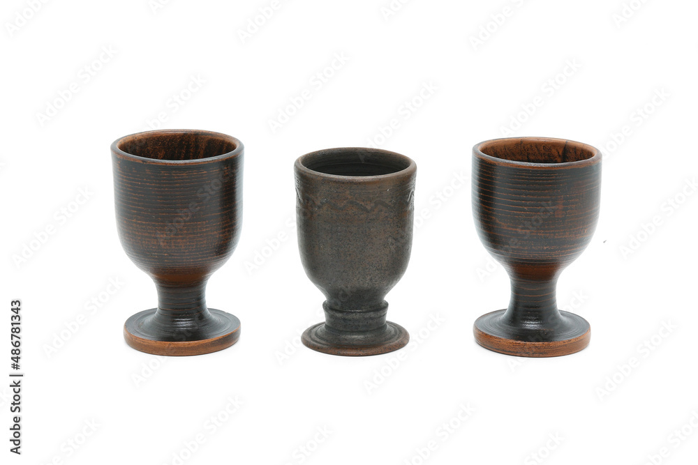 Clay goblets of different shapes isolated on white background. Pottery production. Clay goblets of different shapes isolated on white background. Pottery production.