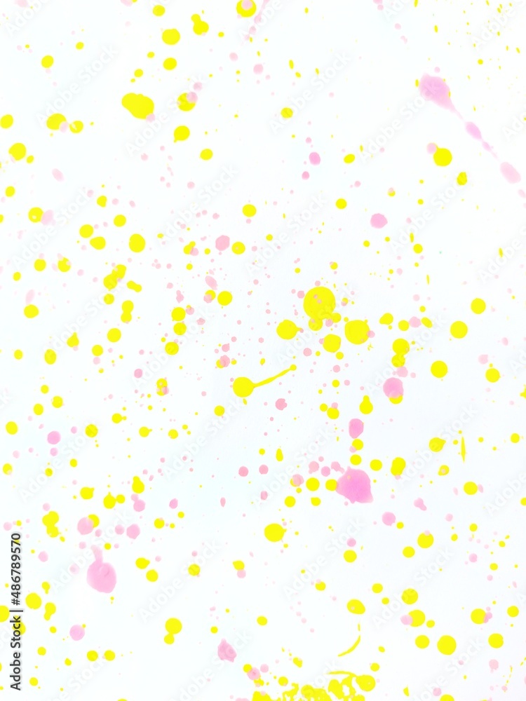 Splash yellow and pink paint on white paper background. Splash yellow and pink paint on white paper background.