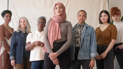 Slow motion of Middle Eastern woman wearing hajib gesturing Break The Bias in support of International Women's Day with female friends