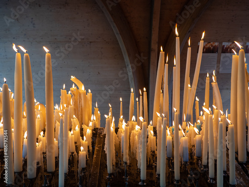 Candles are burning for believe or hope in Lourdes, France.