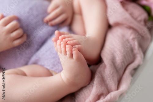small feet of a newborn baby on a white background