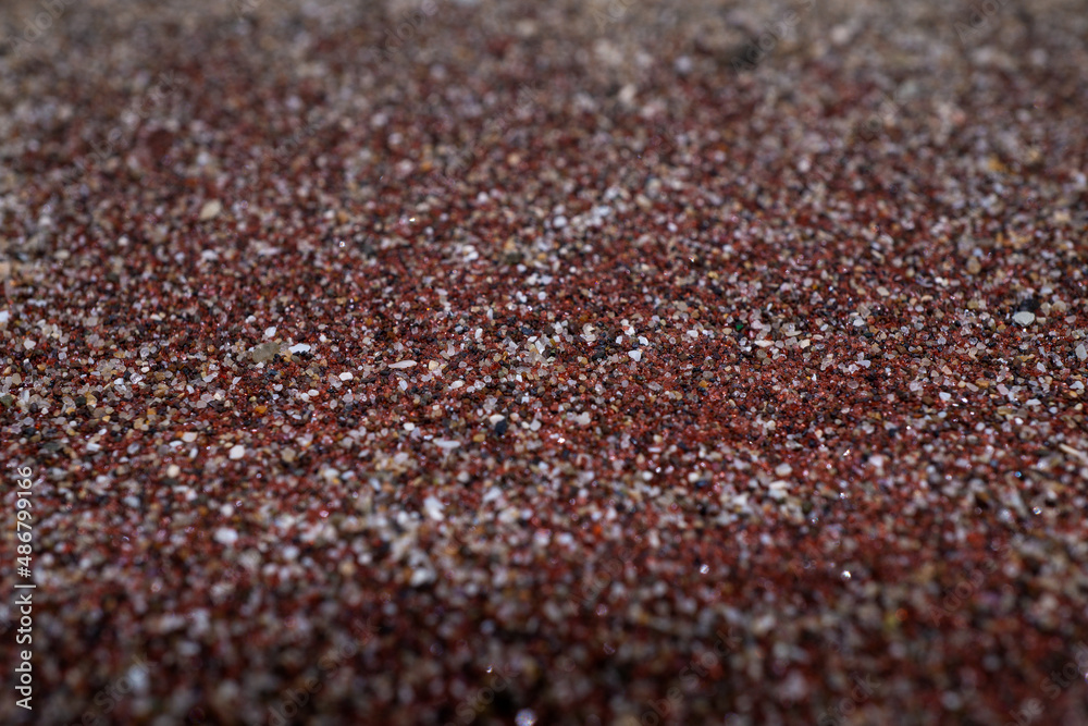 Texture of dry red clay with stones close-up