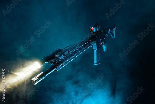 detailed shot dark bold black ar-15 rifle side profile with blue background