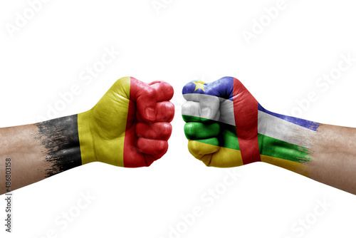 Two hands punch to each others on white background. Country flags painted fists, conflict crisis concept between belgium and central african republic