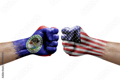 Two hands punch to each others on white background. Country flags painted fists, conflict crisis concept between belize and usa