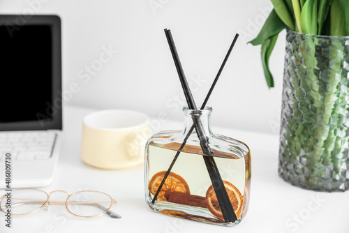 Aroma reed diffuser on table in room