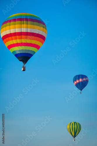 Beautiful colorful hot air balloon flying on the clear blue sky background.