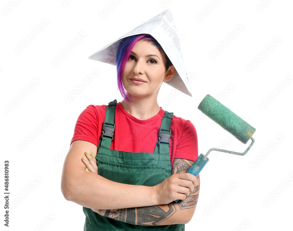 Female painter in paper hat with paint roller on white background Female painter in paper hat with paint roller on white background