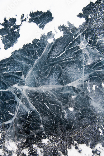 Cracks in the ice with snow 