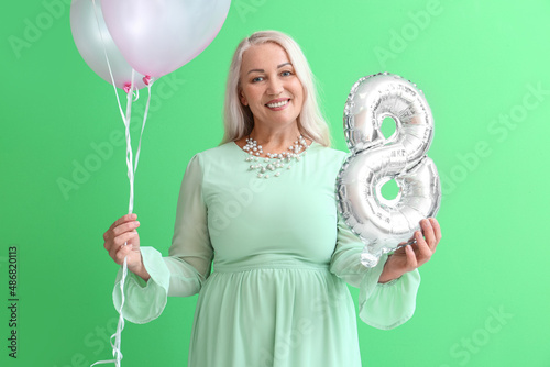 Smiling mature woman holdin...