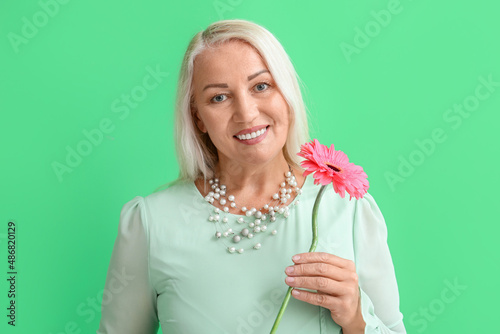 Smiling mature woman holdin...