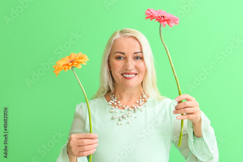 Smiling mature woman holdin...