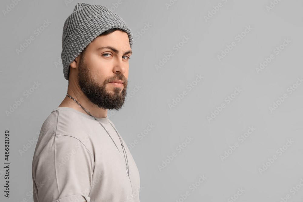 Stylish cool bearded man on grey background Stylish cool bearded man on grey background