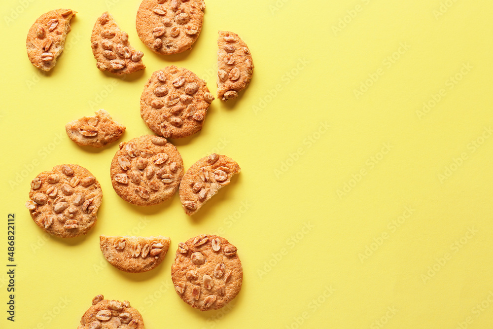 Tasty peanut cookies on yellow background