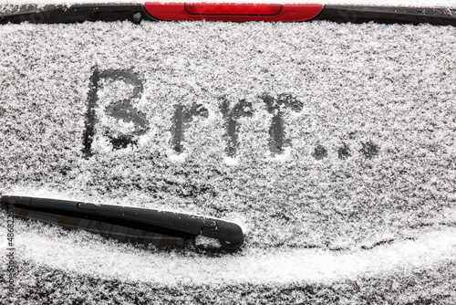 Word BRRR written on car window covered with snow photo