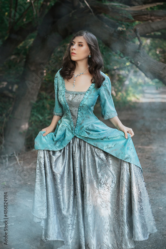 Canvastavla Beautiful young woman in a 19th century dress in a mysterious forest