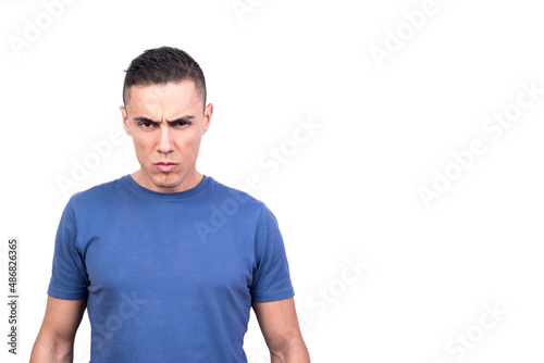 Man standing looking at camera with serious and confrontational expression