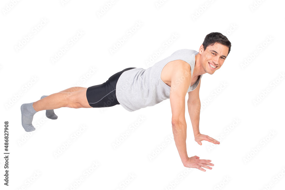 Positive sportsman doing push ups in studio Positive sportsman doing push ups in studio