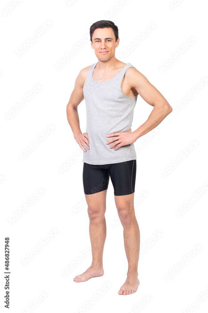 Fototapeta premium Positive sportsman in sportswear standing in studio
