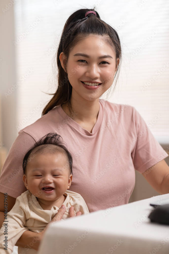 Adorable newborn baby smile and relax in mother arm safety and comfortable.Healthy Asian newborn infant baby laughing with happiness good moment.Mother holding infant baby.Newborn Baby concept Adorable newborn baby smile and relax in mother arm safety and comfortable.Healthy Asian newborn infant baby laughing with happiness good moment.Mother holding infant baby.Newborn Baby concept