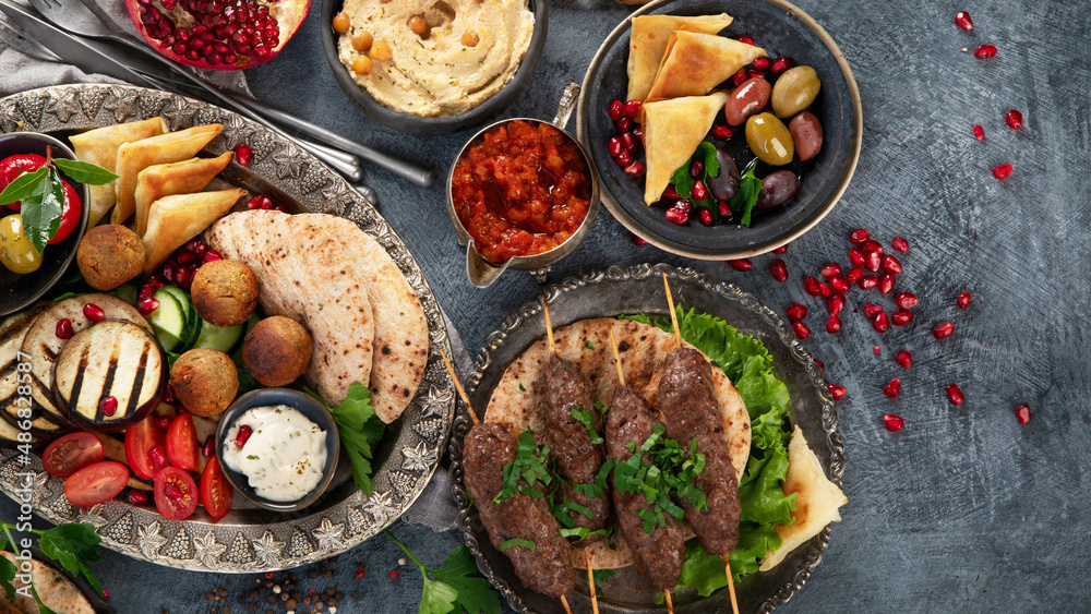 Arabic food assortment on dark background.